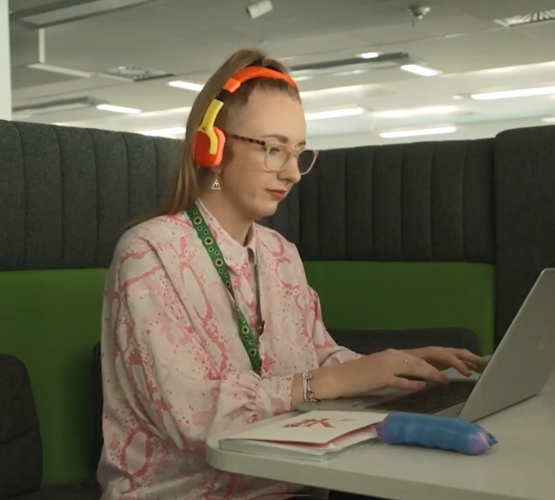 Sellafield employee at a desk with headphones