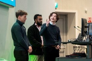 Three colleagues in conversation at a conference