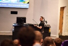 A speaker presenting to a seated audience